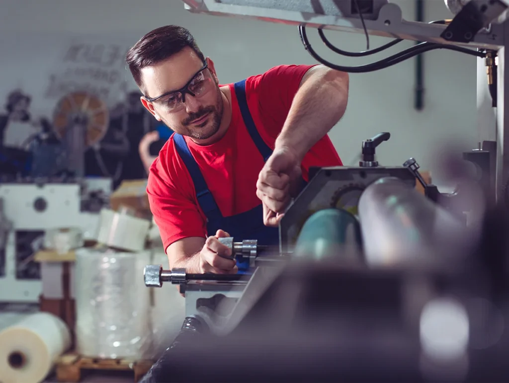 man working on his factory machines in his business