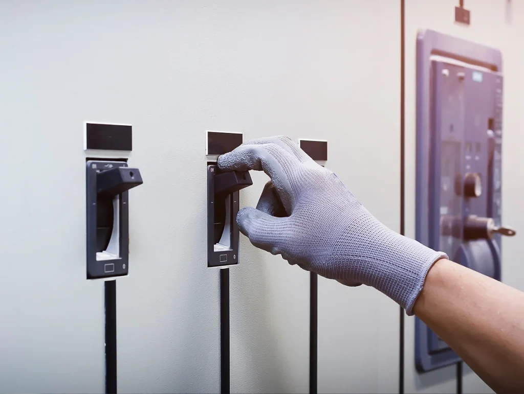 hand pulling large electrical switch