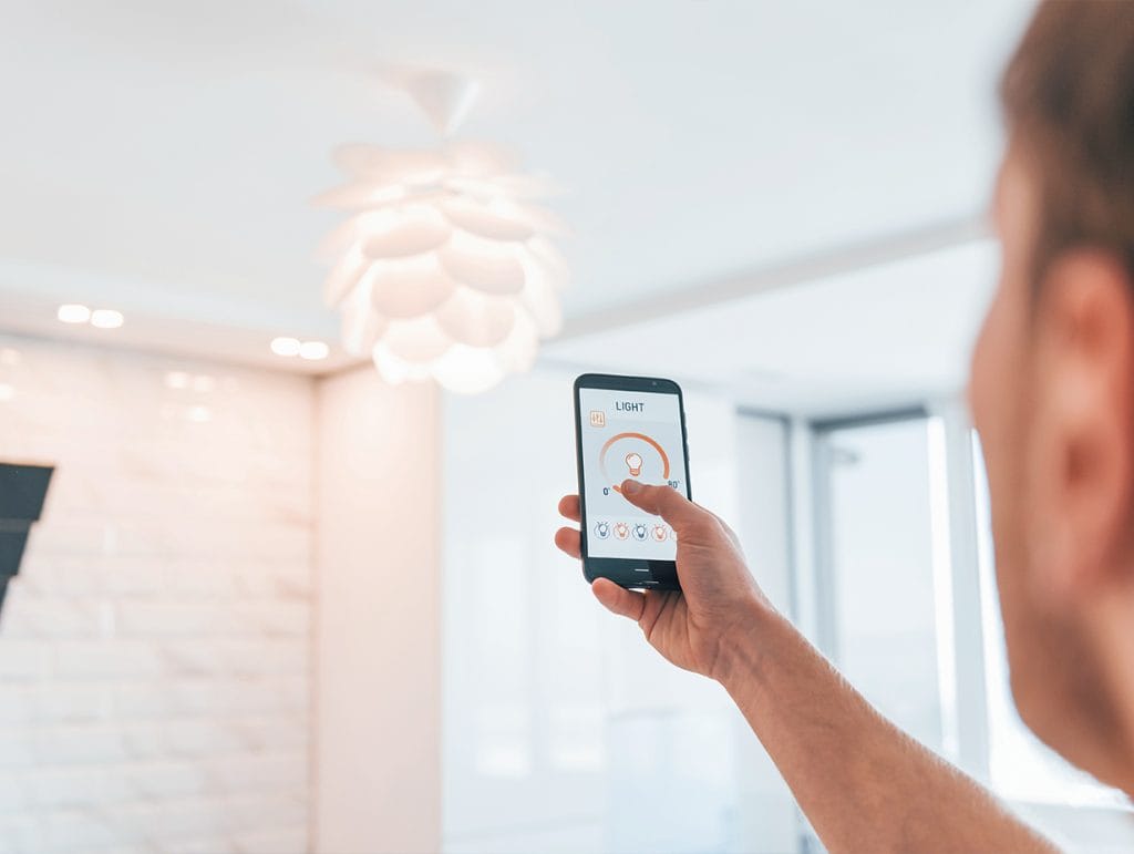 person using their smart thermostat app onm their phone