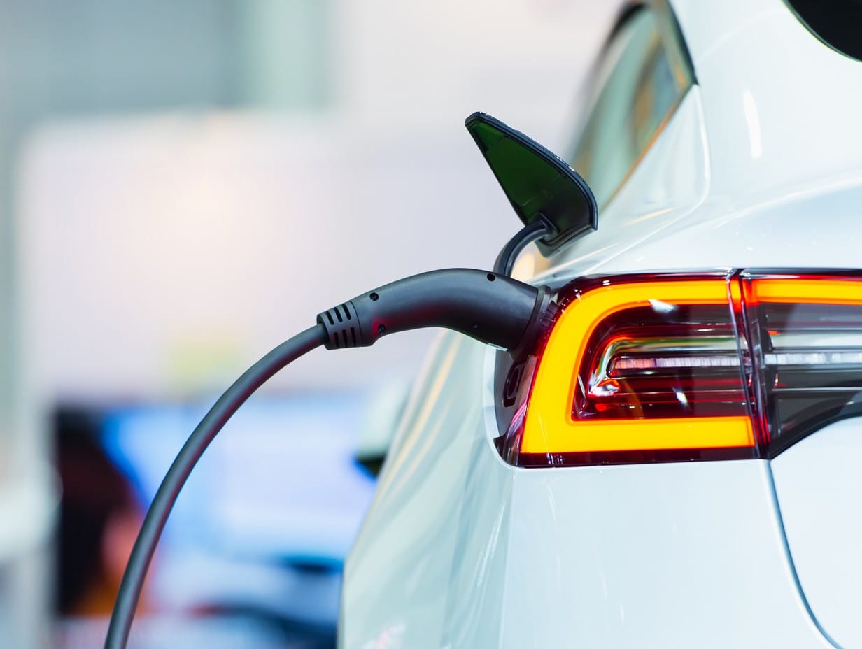 white ev car parked while charging